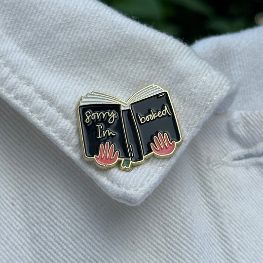 Pin “Sorry, I’m booked” (Hands Holding a Book)