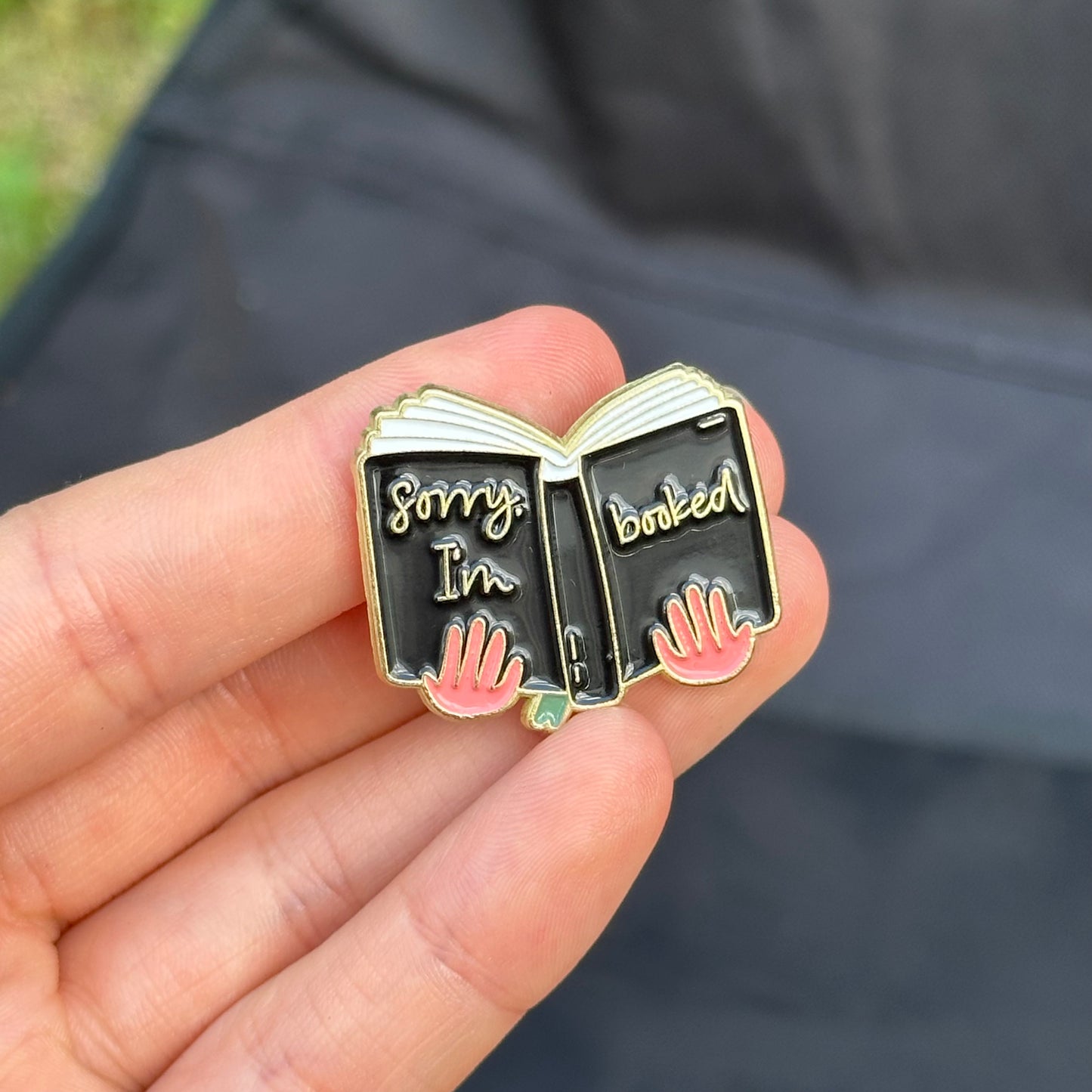 Pin “Sorry, I’m booked” (Hands Holding a Book)