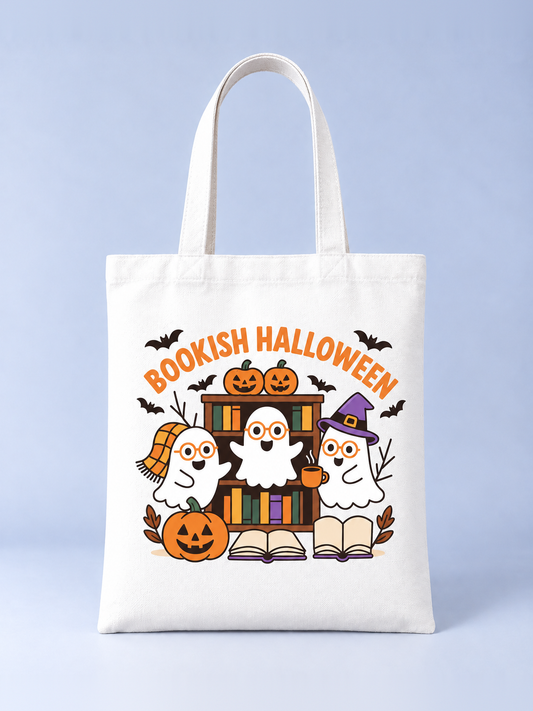 Bookish Halloween tote bag, front view – cream canvas tote with three reading ghosts in glasses, bookshelf and jack-o'-lanterns print