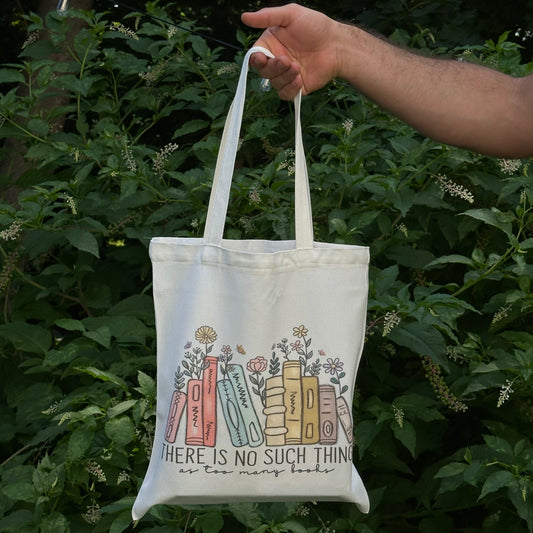 Reusable cotton tote bag with the quote “There is no such thing as too many books” — ideal for book lovers, readers, and bookworms