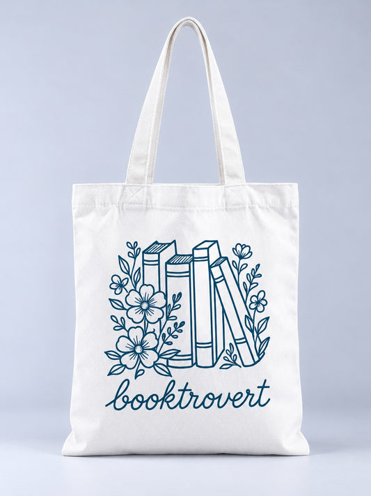 Booktrovert tote bag, front view with blue line-art books and flowers print