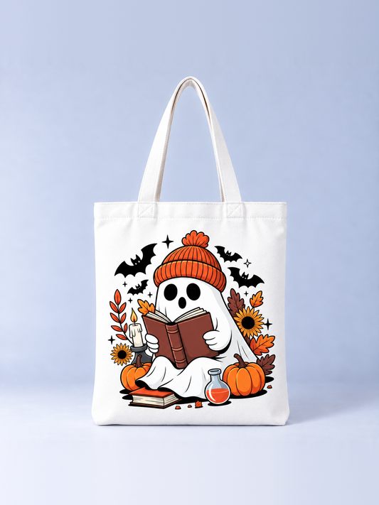 Cozy Fall Ghost Halloween tote bag, front view – cream canvas tote with a ghost in an orange beanie reading among pumpkins, sunflowers and bats print