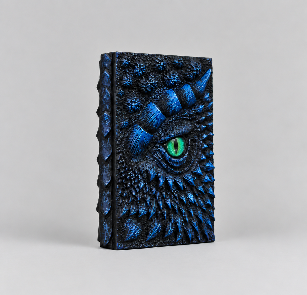 Front cover of the blue 3D dragon eye journal with a green eye, embossed resin notebook