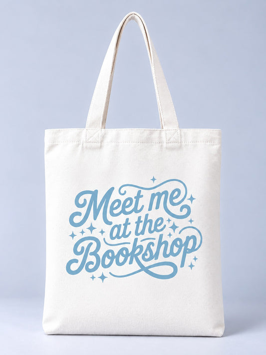 Meet Me at the Bookshop tote bag, front view with light blue script lettering and sparkles