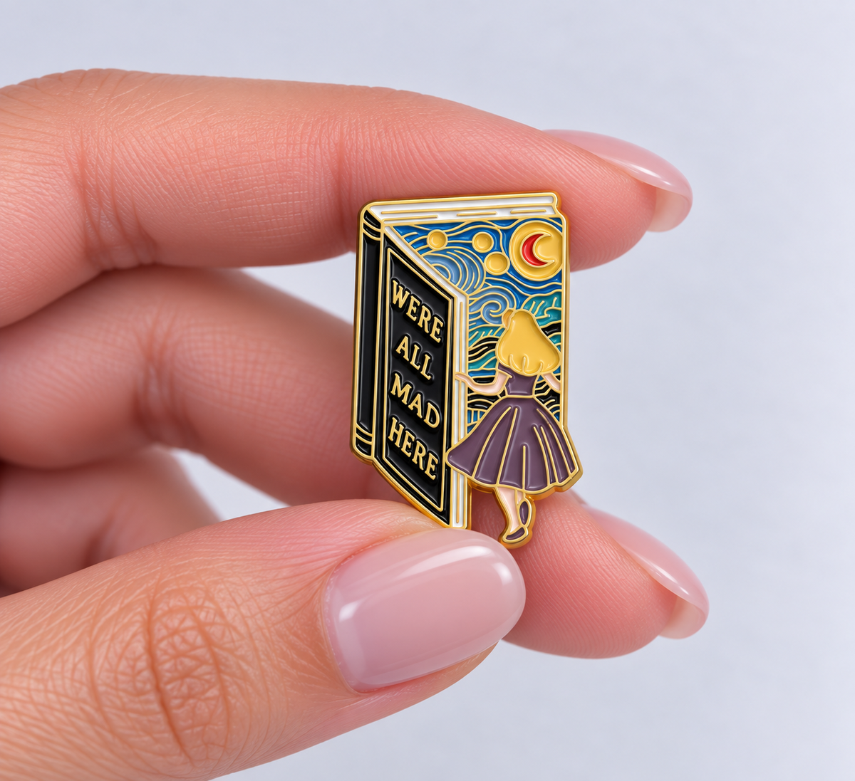 We're All Mad Here Alice in Wonderland book pin held in hand to show its size